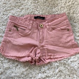 Light pink denim shorts.